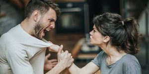 An intense argument between spouses in their living room, a representation of the tension and confrontation that can follow the evidence of an affair. 